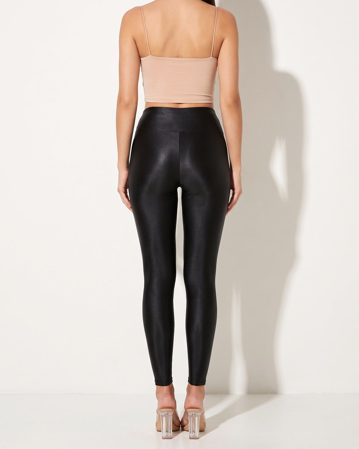 Black shiny tricot leggings, back view on model