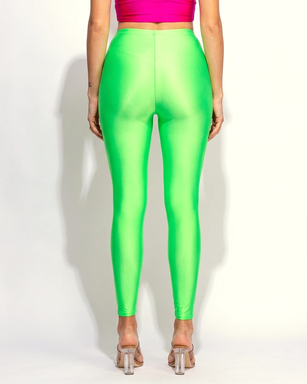 Neon lime shiny tricot leggings, back view on model