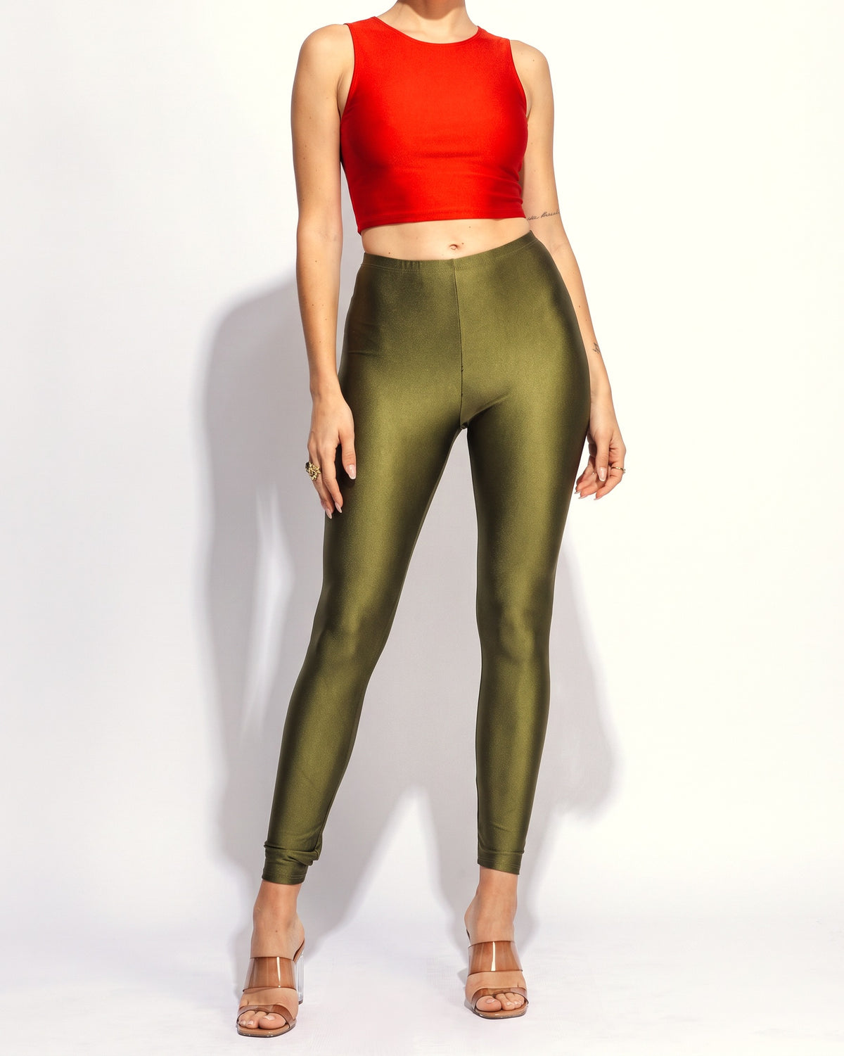Olive shiny tricot leggings, front view on model