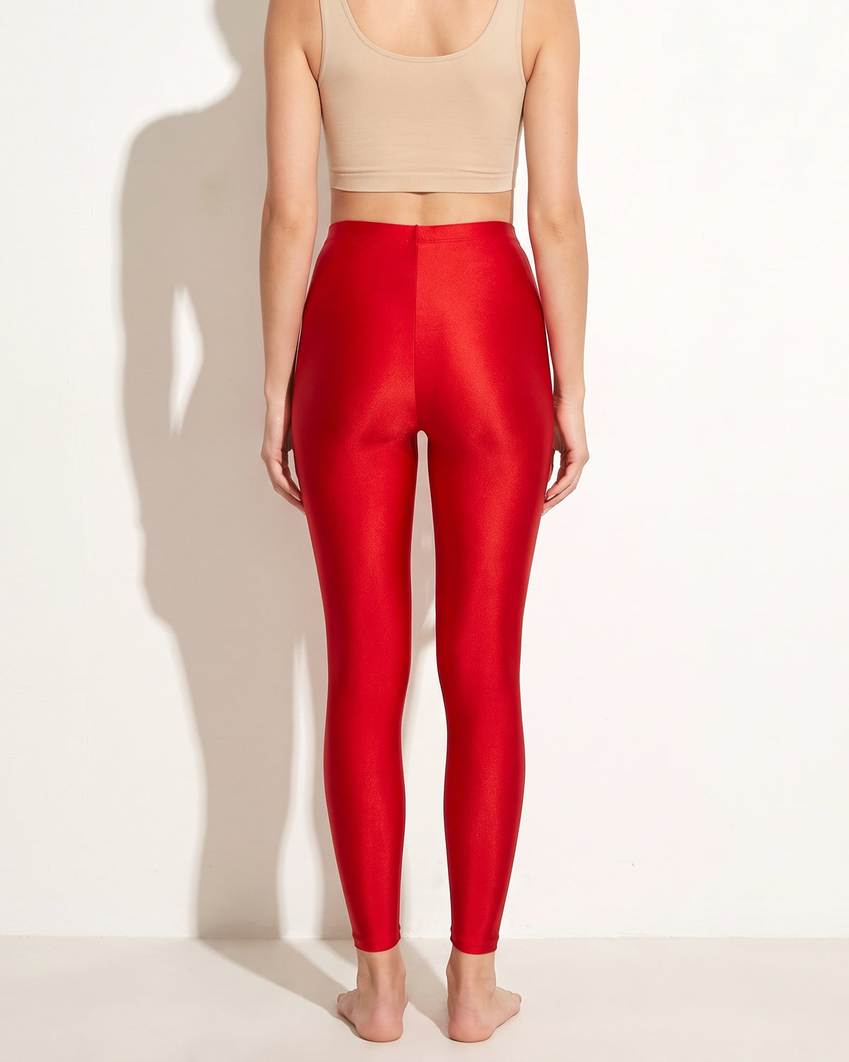 Red shiny tricot leggings, back view on model