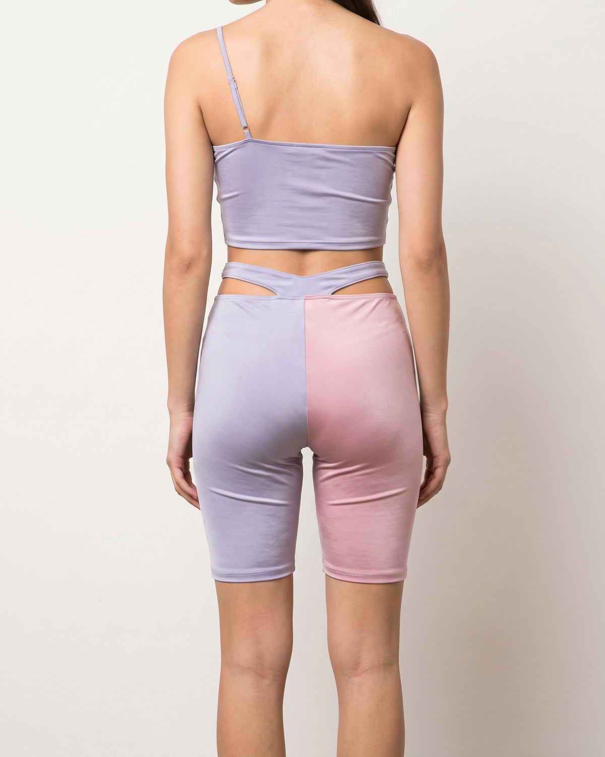 Lavender and blush satin color block biker shorts set, back view on model