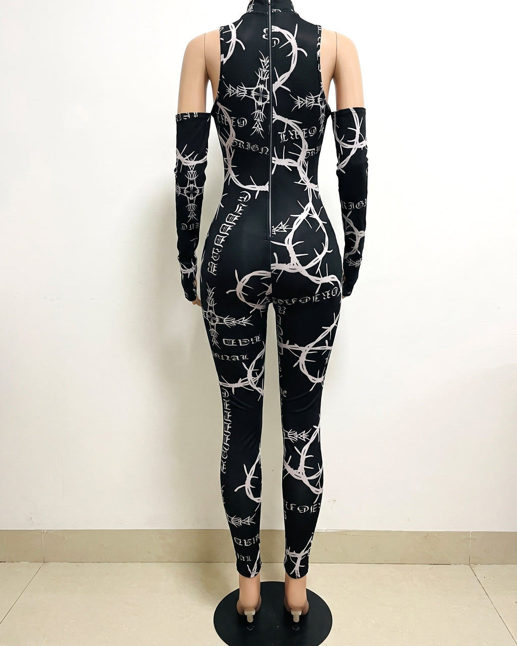 Black barbed wire printed mesh jumpsuit, back view on model