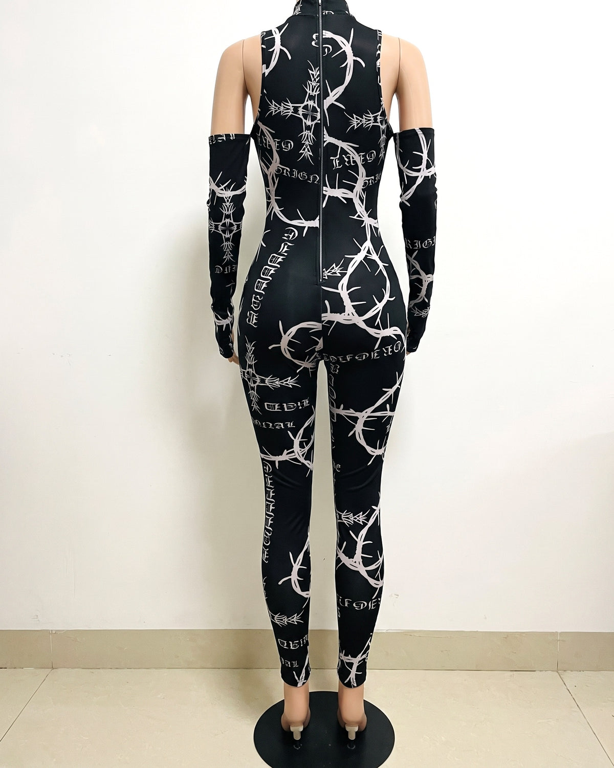 Black barbed wire printed mesh jumpsuit, back view on model