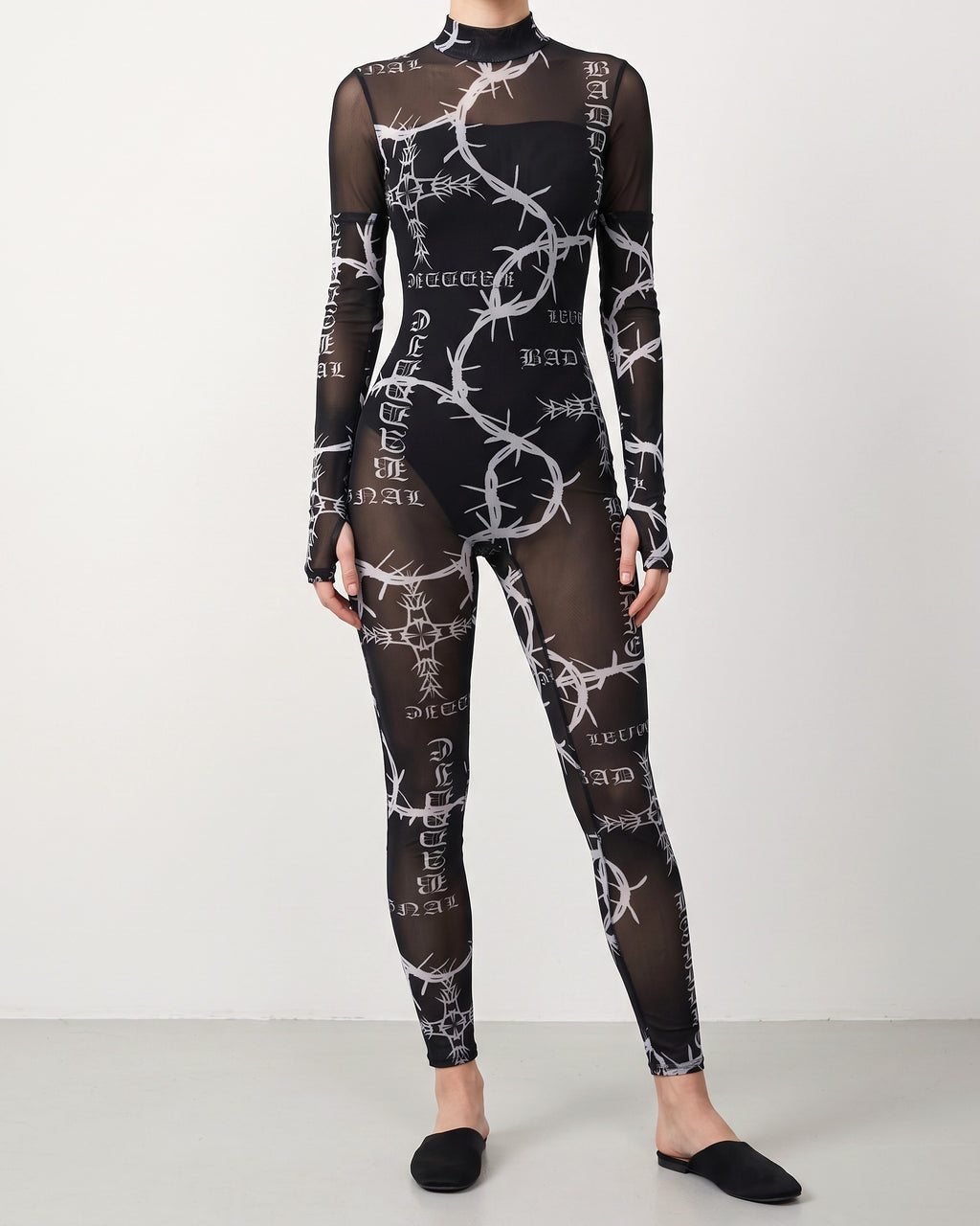Muvin women's black barbed wire printed mesh jumpsuit, front view on model