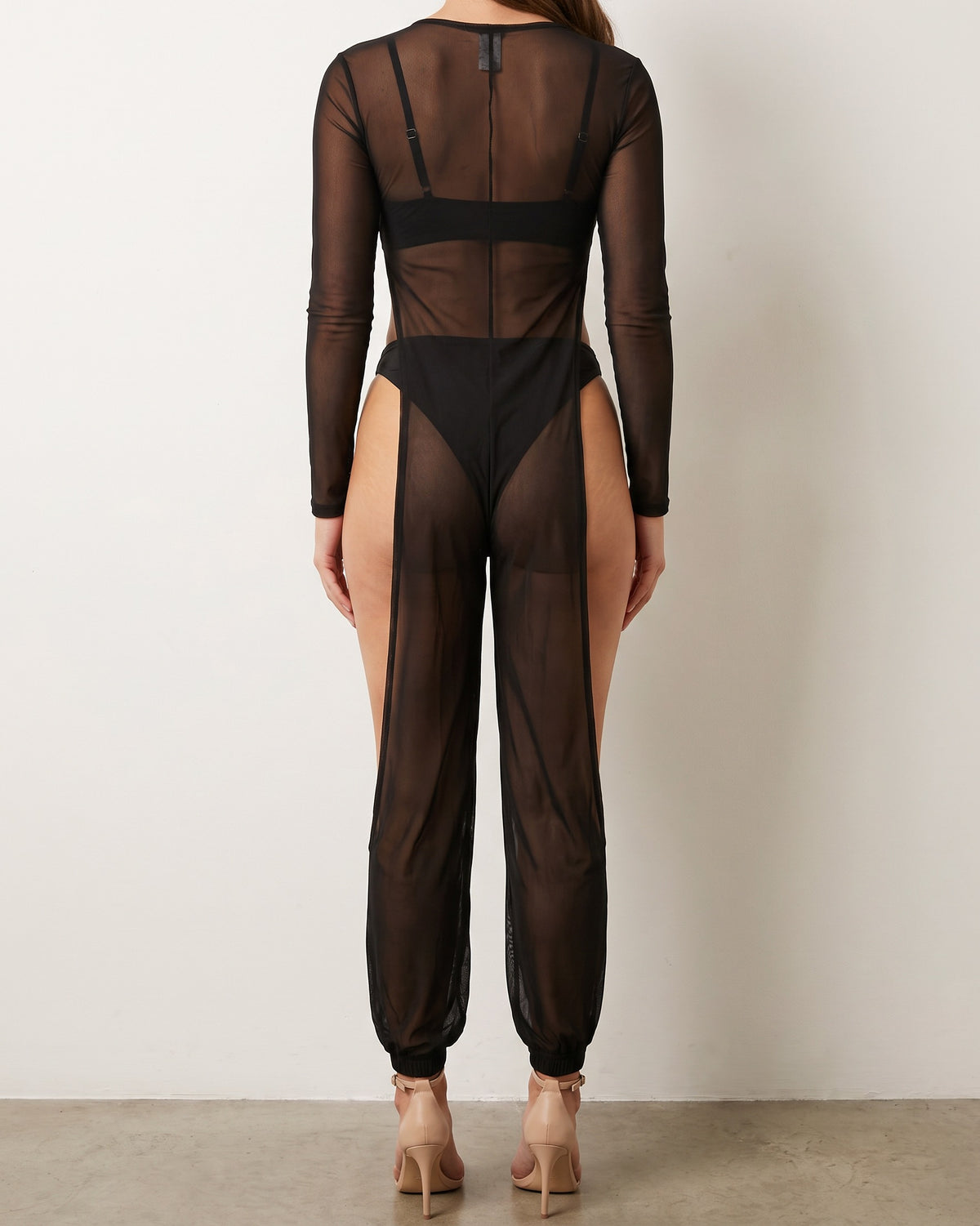 Black mesh coverup jumpsuit, back view on model