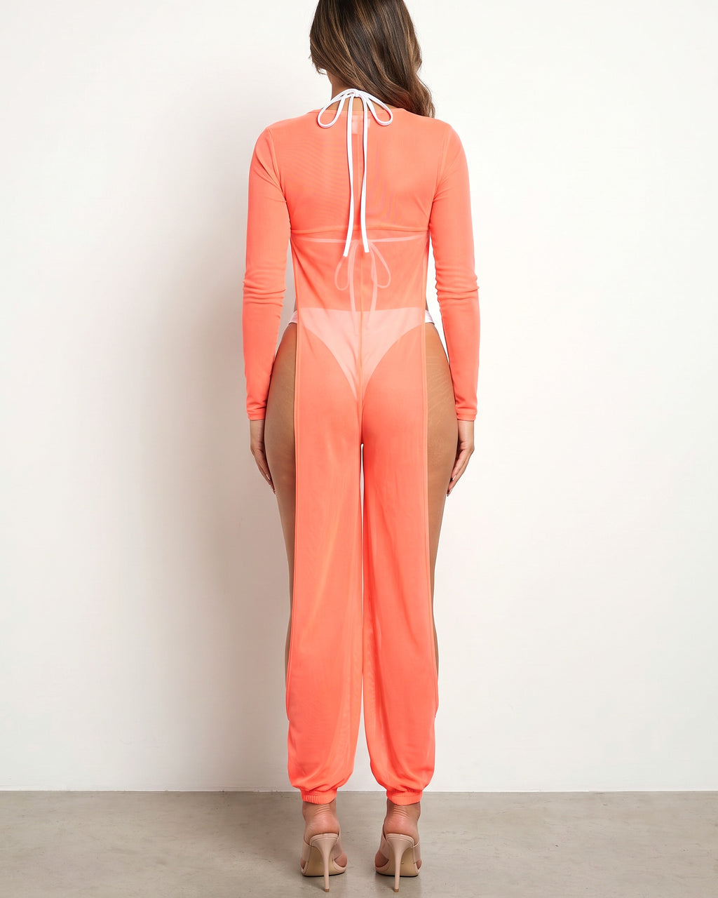 Neon coral mesh coverup jumpsuit, back view on model