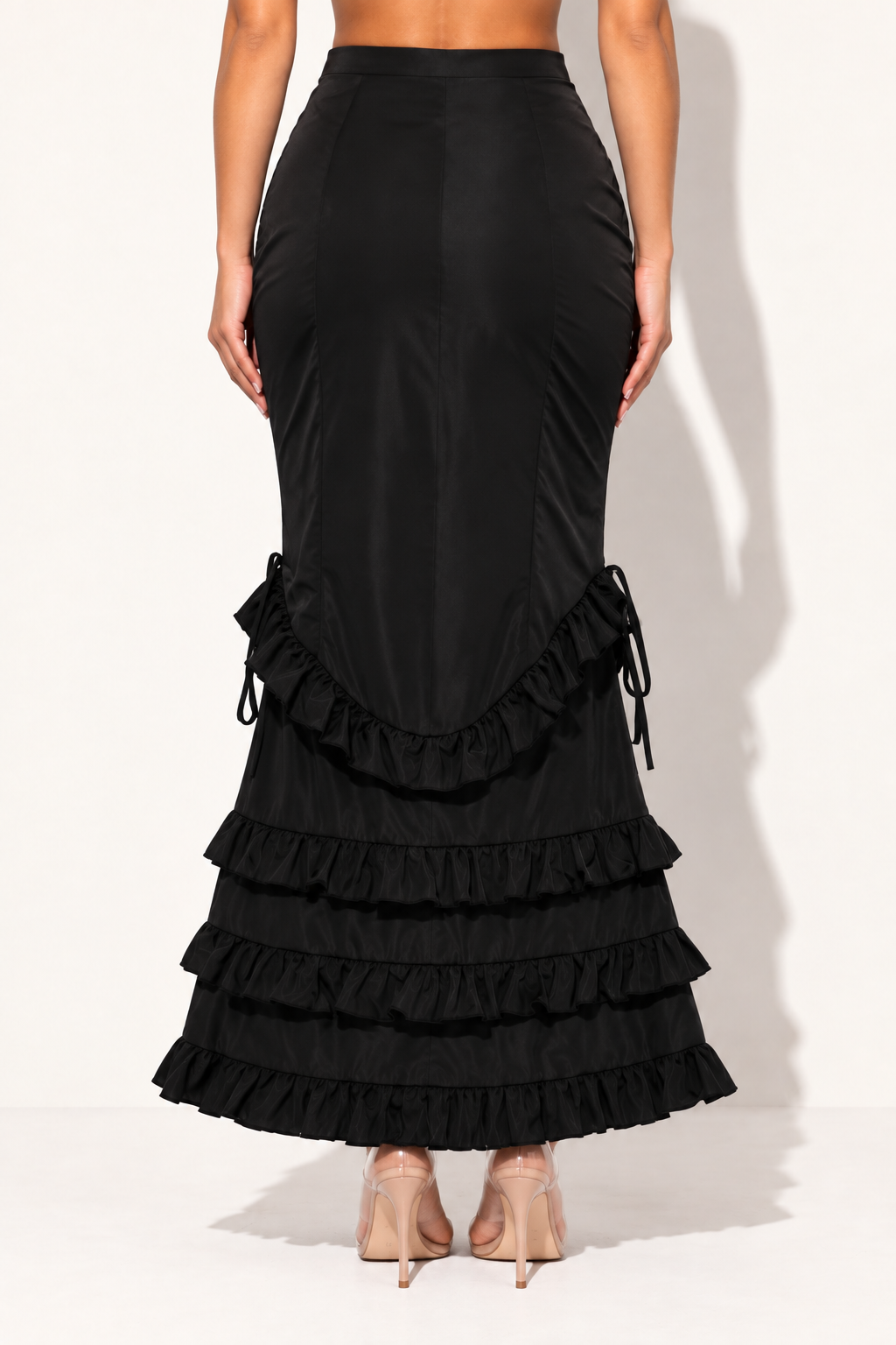 Black ruffle maxi skirt, rear view showing smooth back panel and tiered ruffles