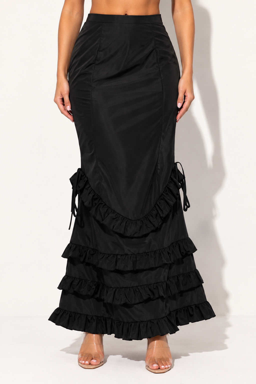 Muvin women's black ruffle maxi skirt, front view showing curved ruffle seam and layered hem