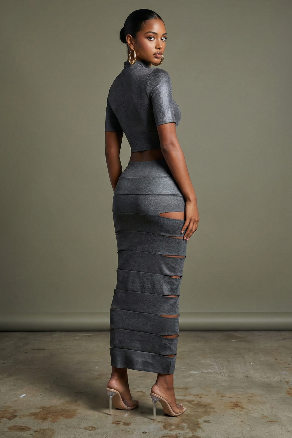 Grey laser cut mesh two-piece crop top and maxi skirt, side profile