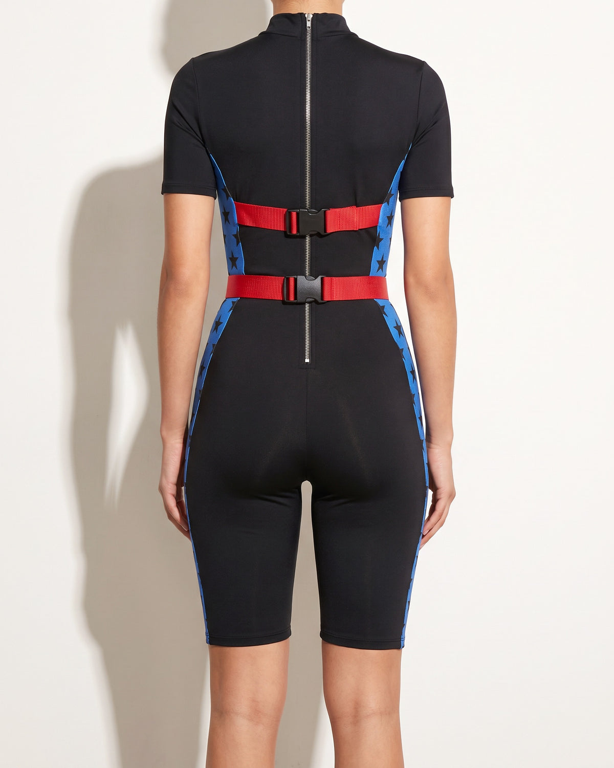 Black star buckle strap jumpsuit, back view on model