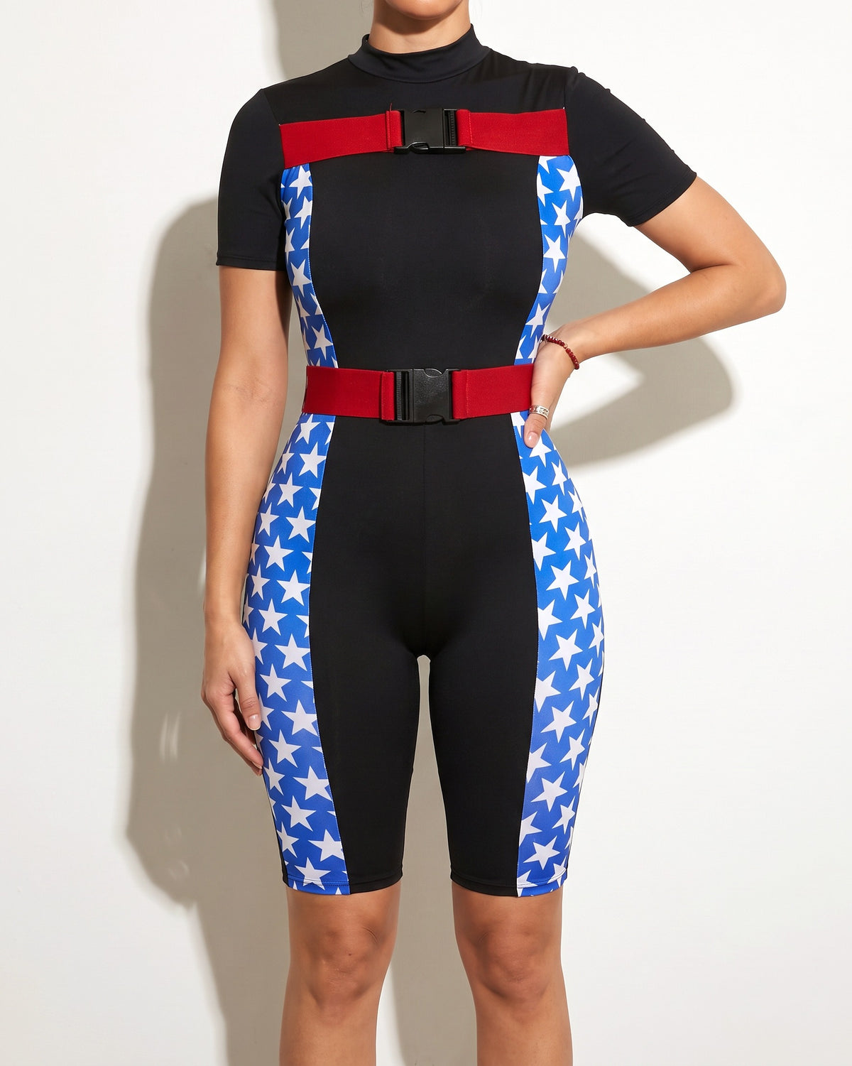 Black star buckle strap jumpsuit, alternate front view on model