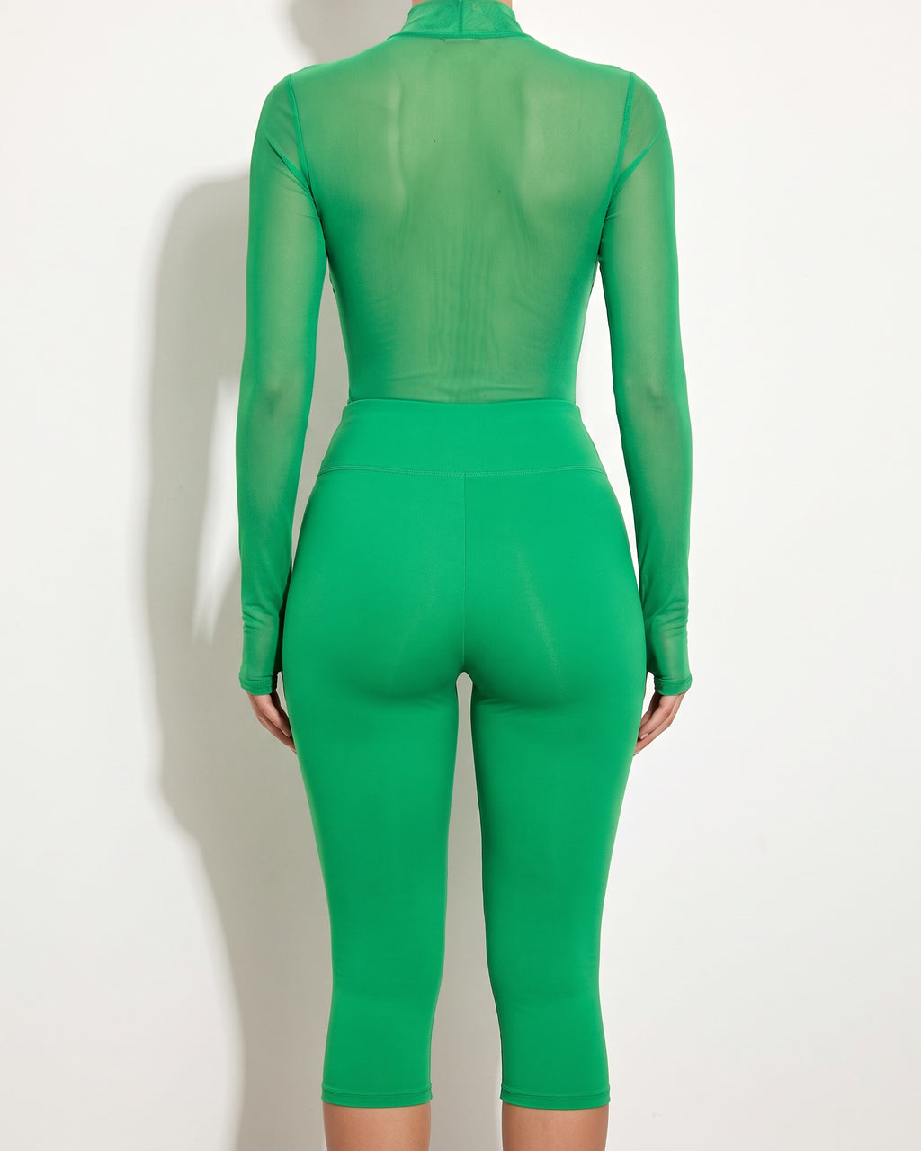 Kelly green rhinestone underboob trimmed bodysuit, back view on model