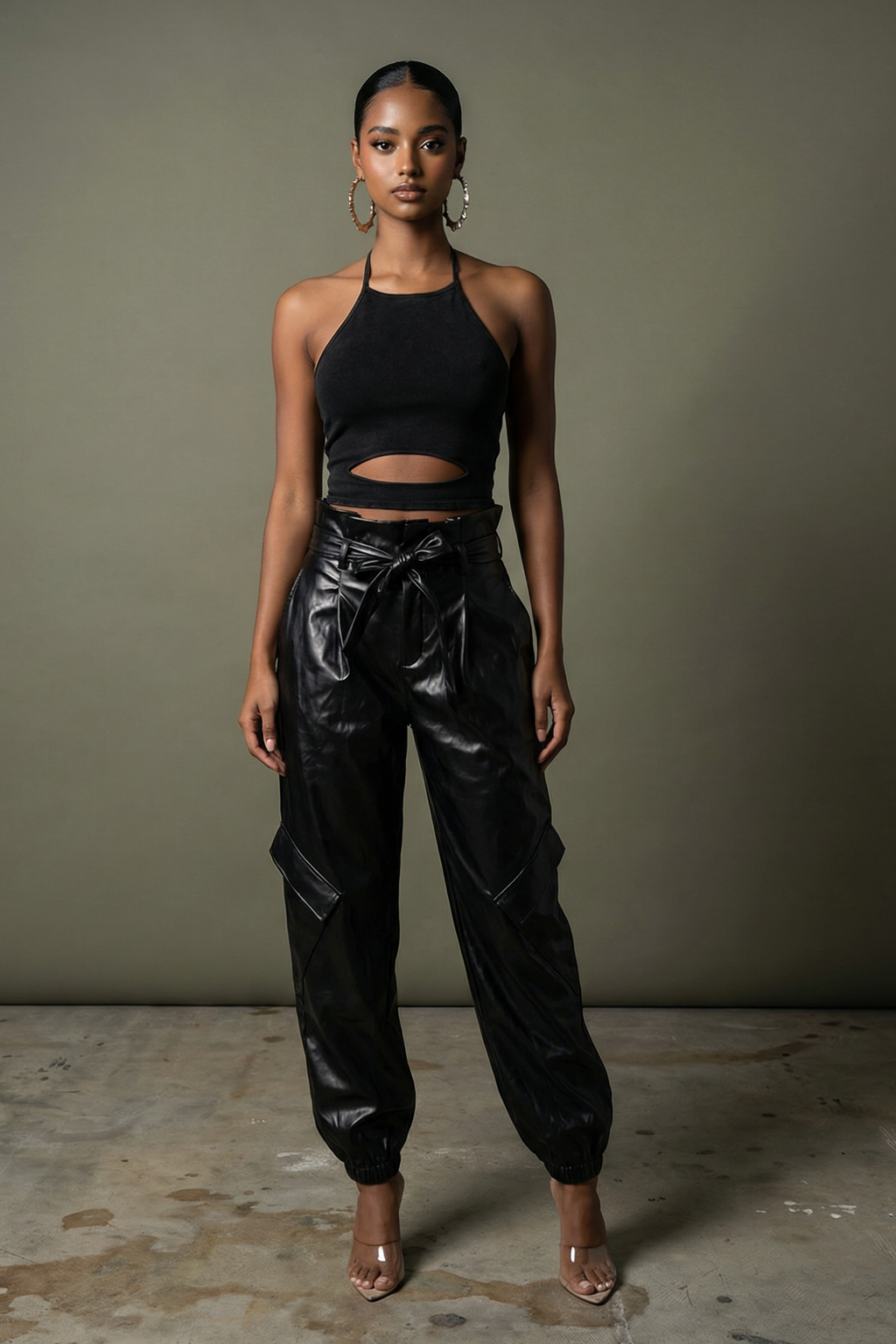 Black metallic PU leather tapered leg jogger pants with elastic waist, front view