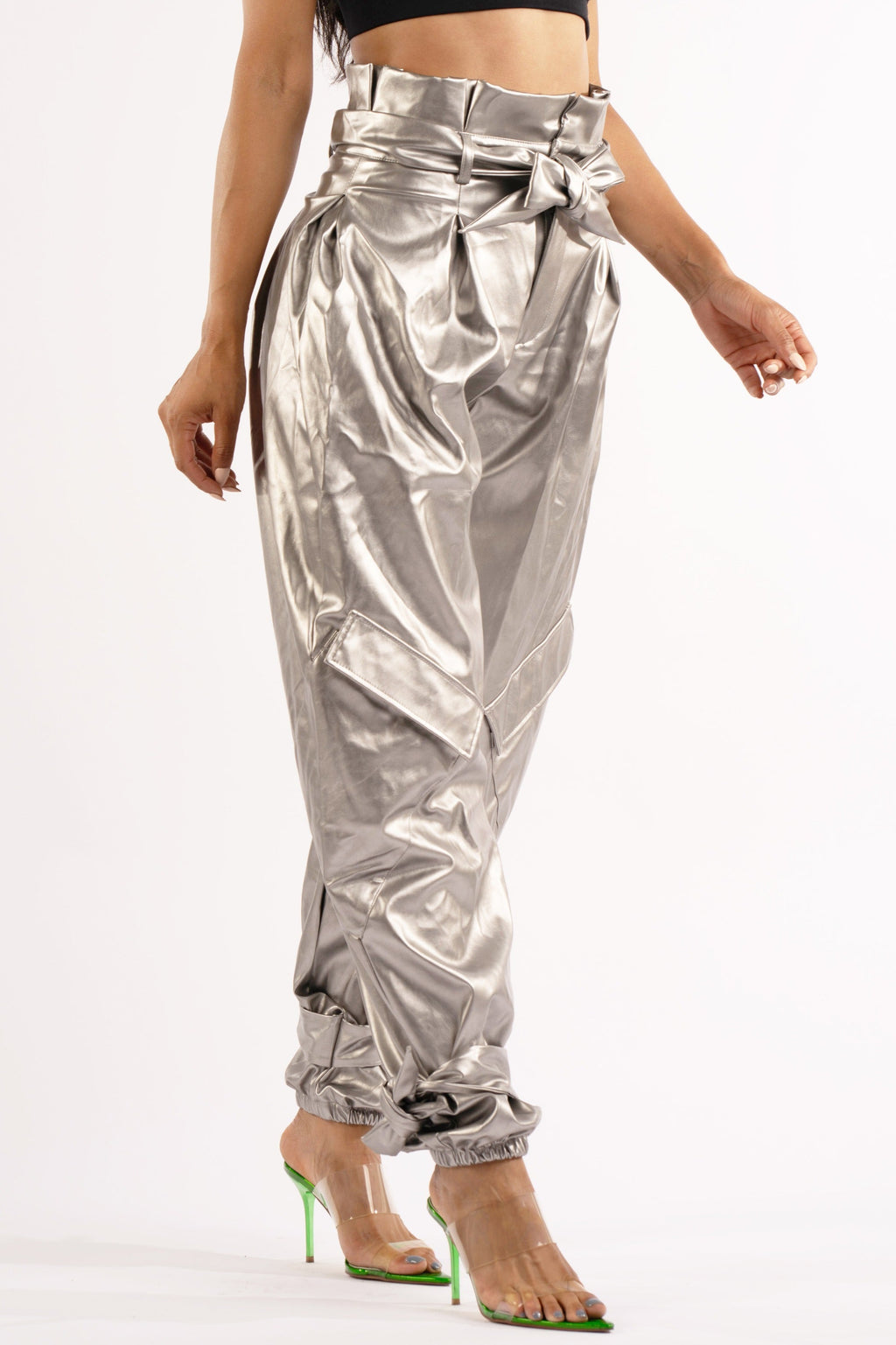 Silver metallic PU jogger pants, detail view on model