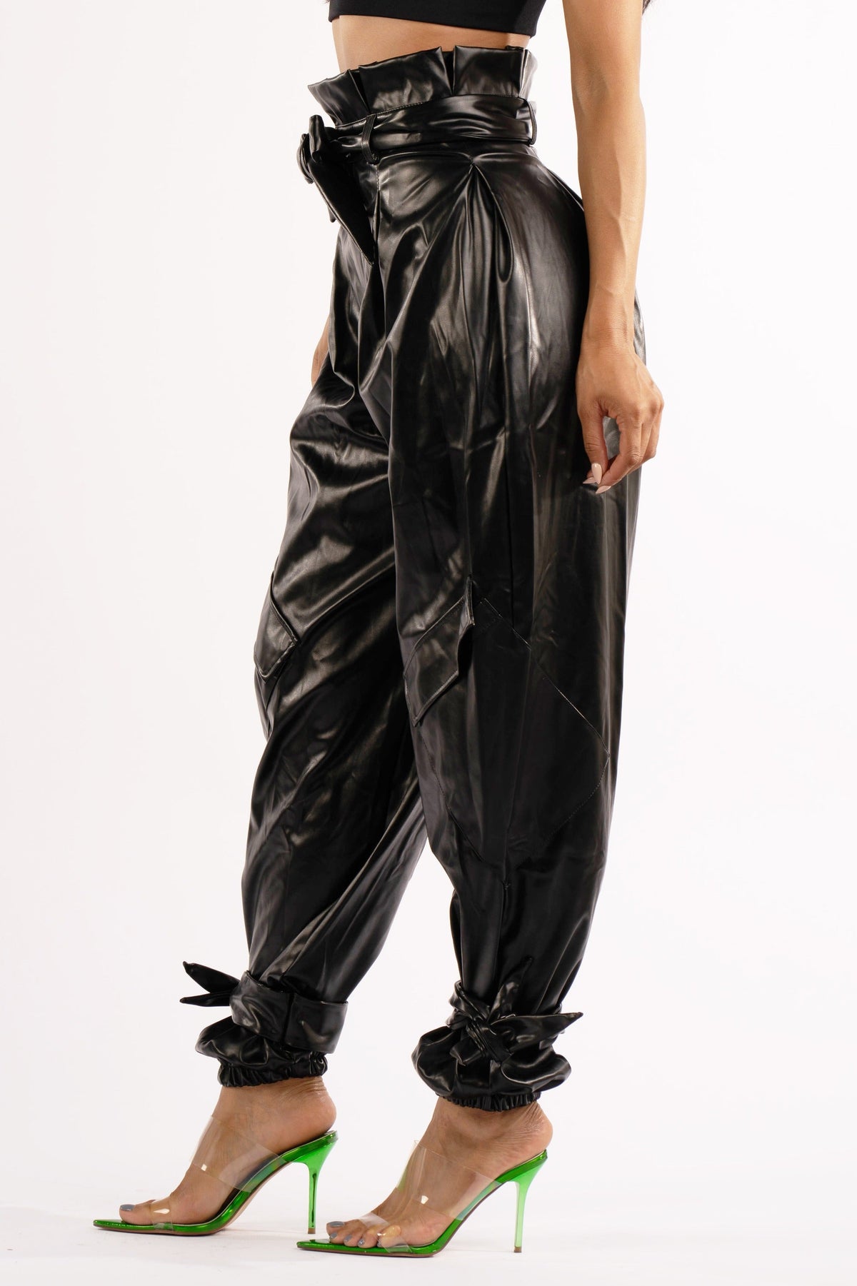 Black metallic PU jogger pants, detail view on model