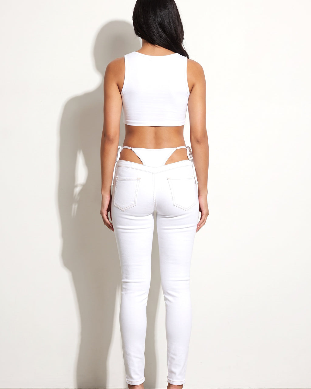 White bikini cutout denim pants, back view on model