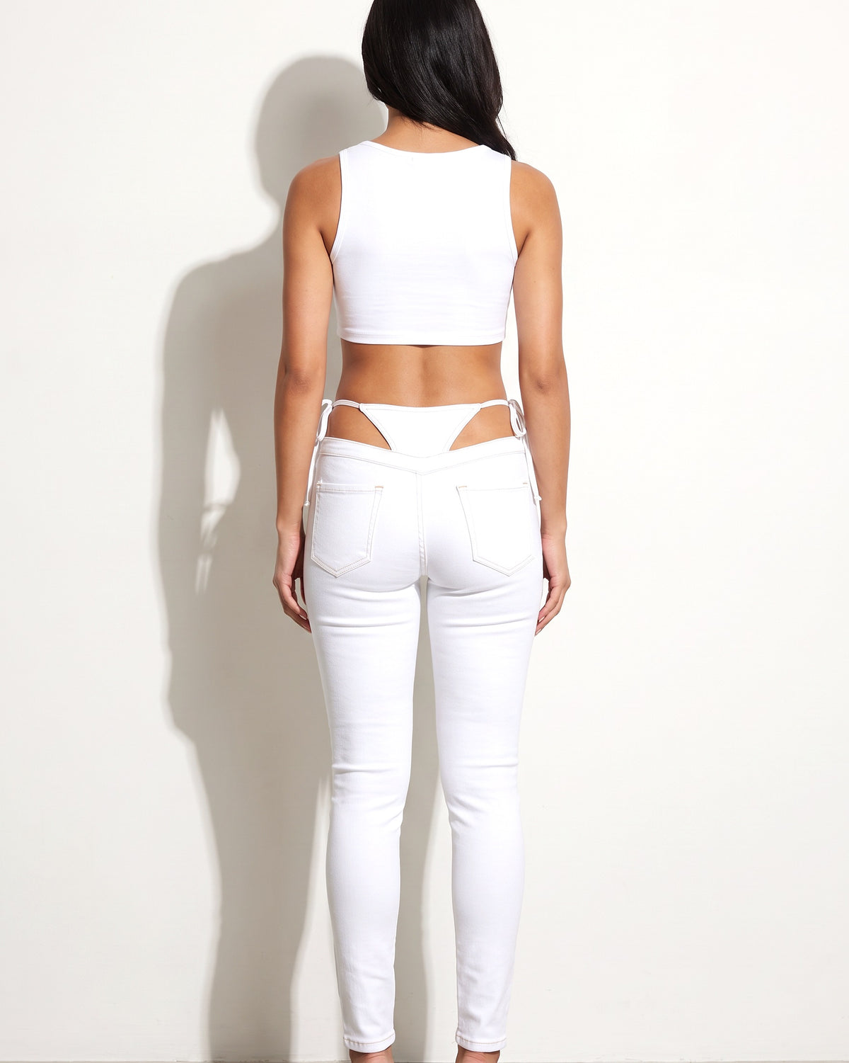 White bikini cutout denim pants, back view on model