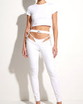 Muvin women's white bikini cutout denim pants, front view on model