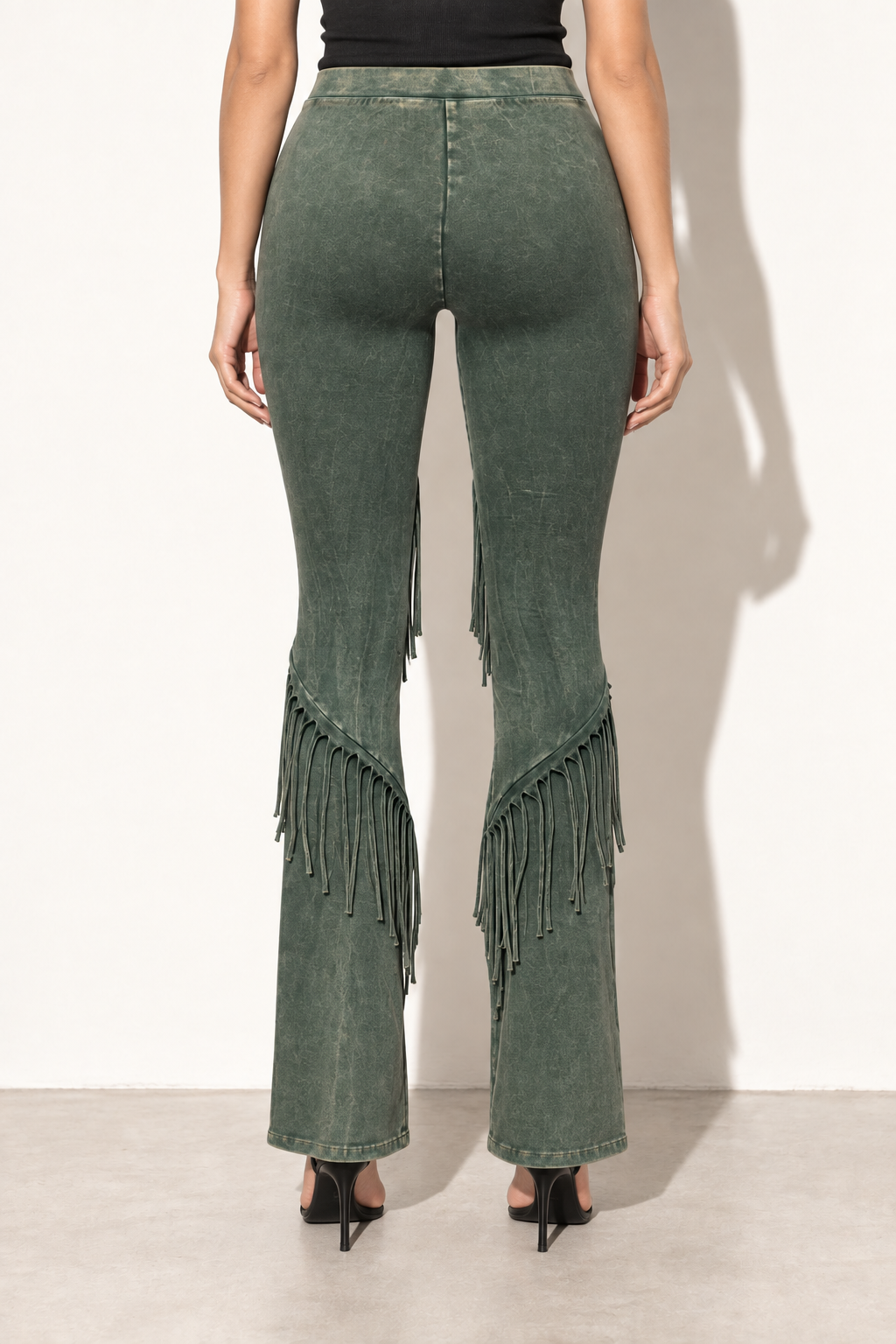 Olive mineral washed fringe flare pants, back view with plain upper panels and diagonal calf fringe