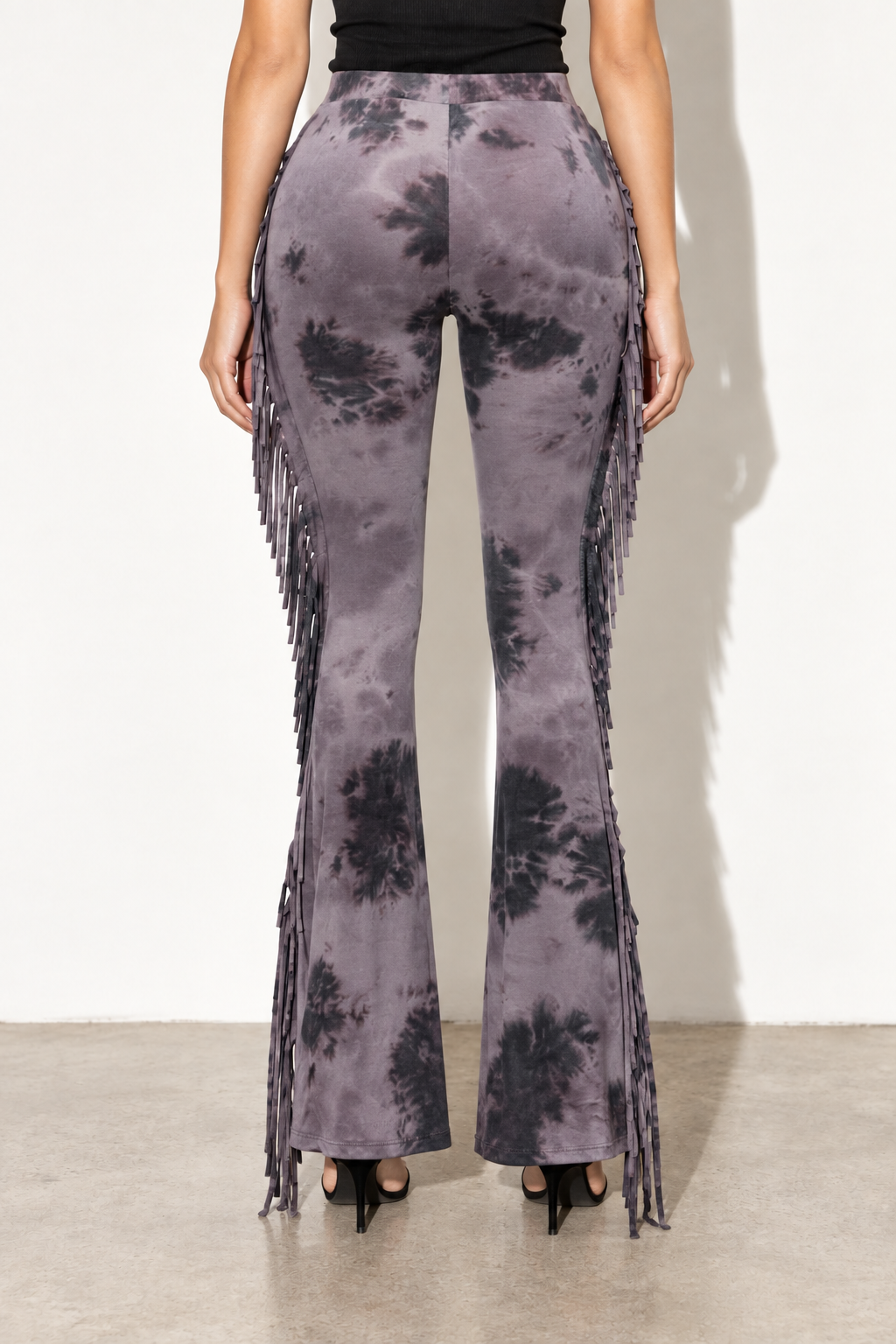 Grey combo tie dye fringe flare pants, back view showing center seam and grey tie dye pattern