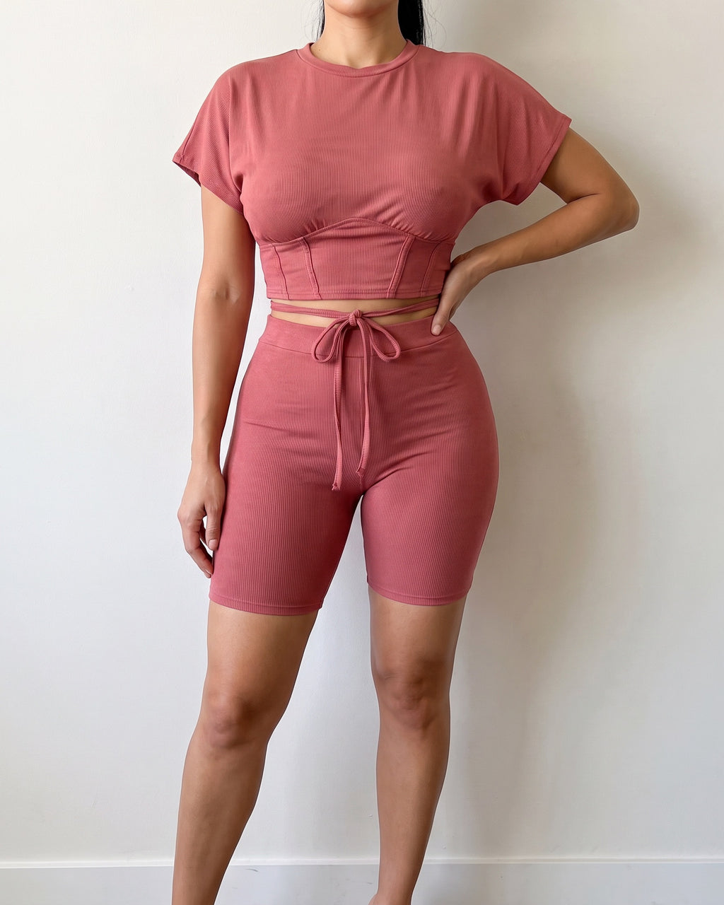 Mauve corseted top and biker set, alternate front view on model