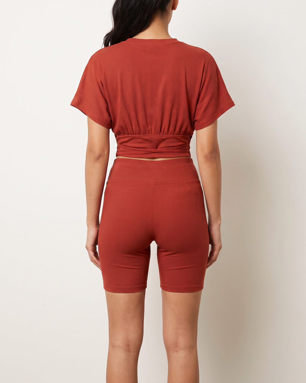Rust corseted top and biker set, back view on model