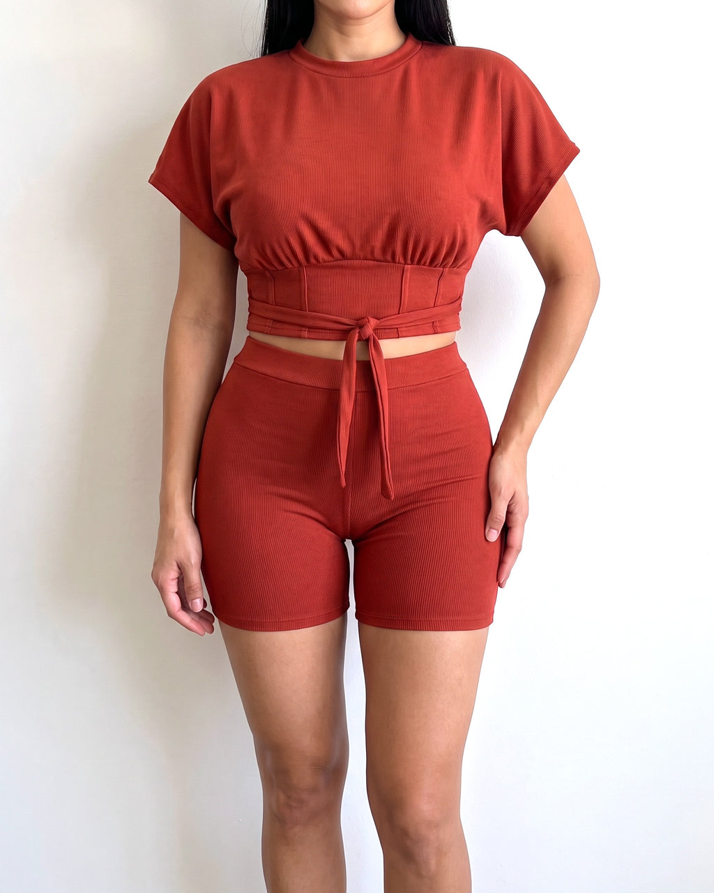Rust corseted top and biker set, alternate front view on model