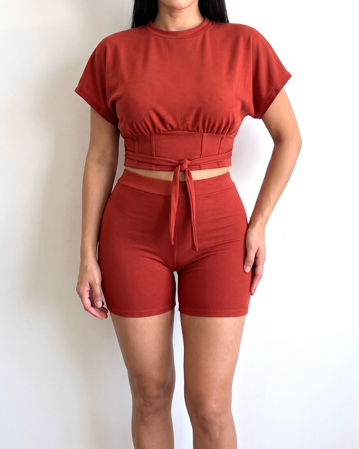Rust corseted top and biker set, alternate front view on model