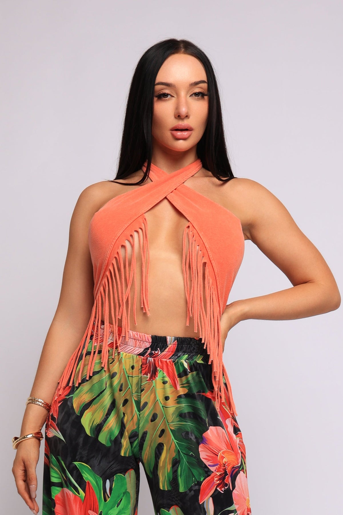 Orange fringe halter crop top, detail view on model