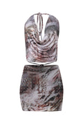 Two-piece outfit with a patterned top and skirt on a white background