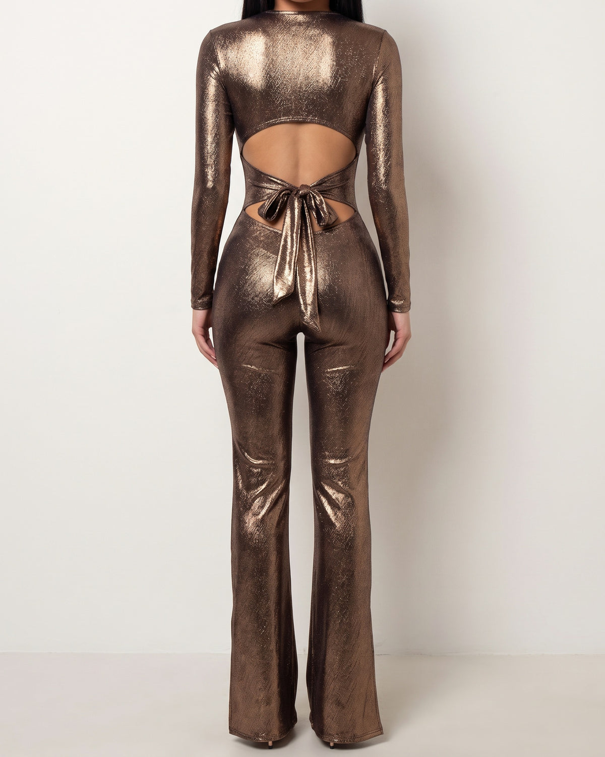 Bronze tie back slit detailed jumpsuit, back view on model