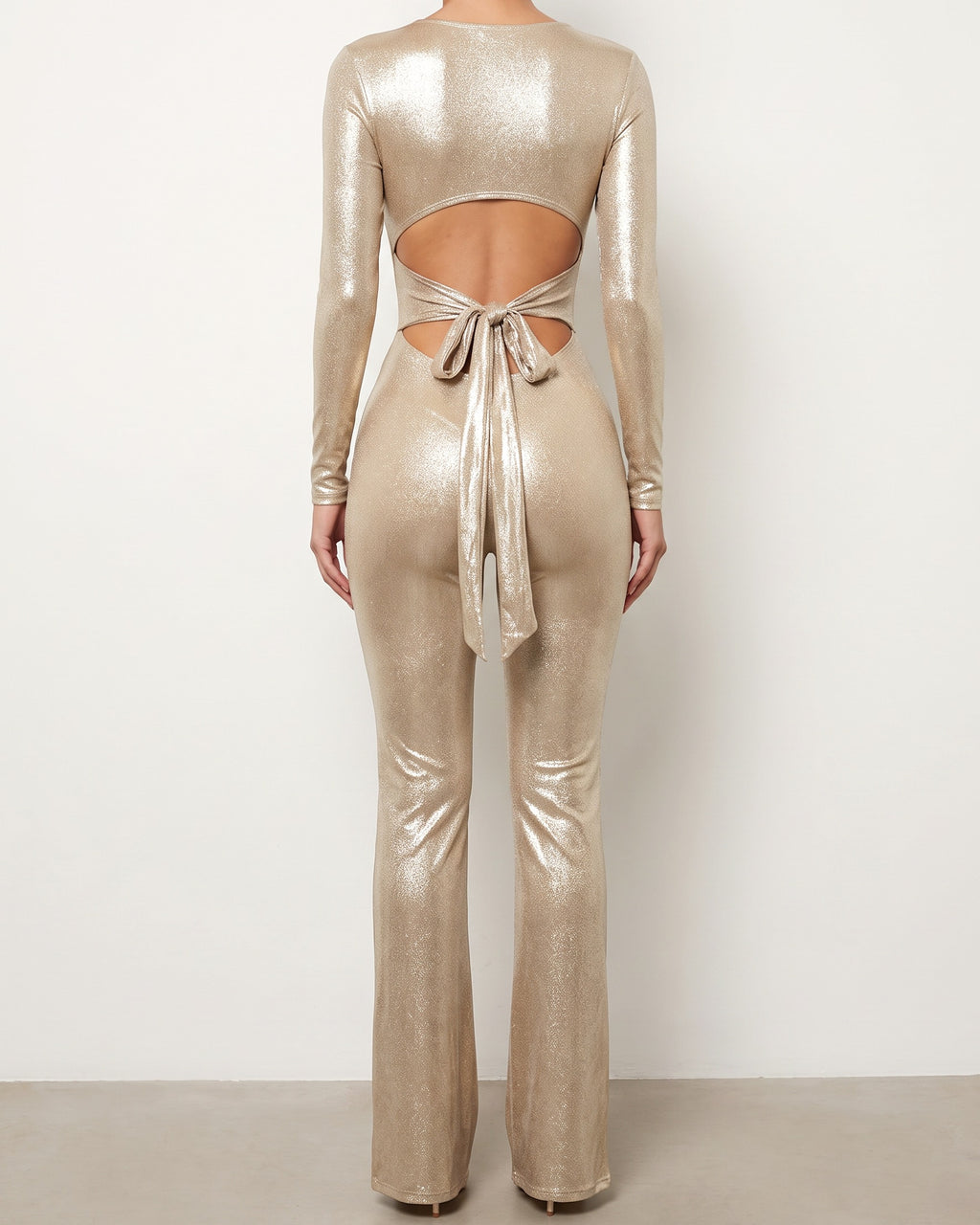 Gold tie back slit detailed jumpsuit, back view on model