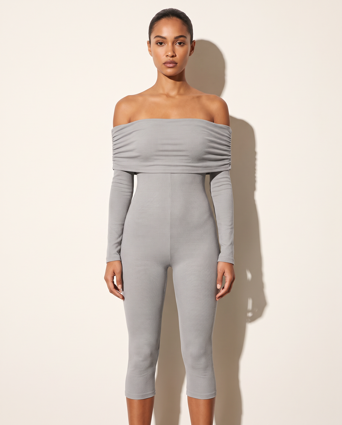 Grey off-shoulder long-sleeve capri jumpsuit, front view on model