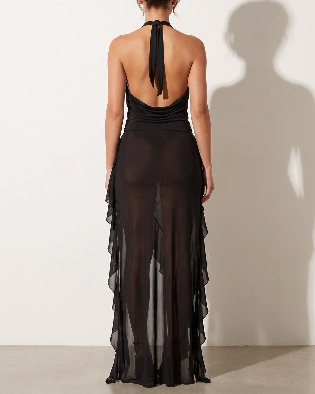 Black cowl halter ruffled skirt set, back view on model