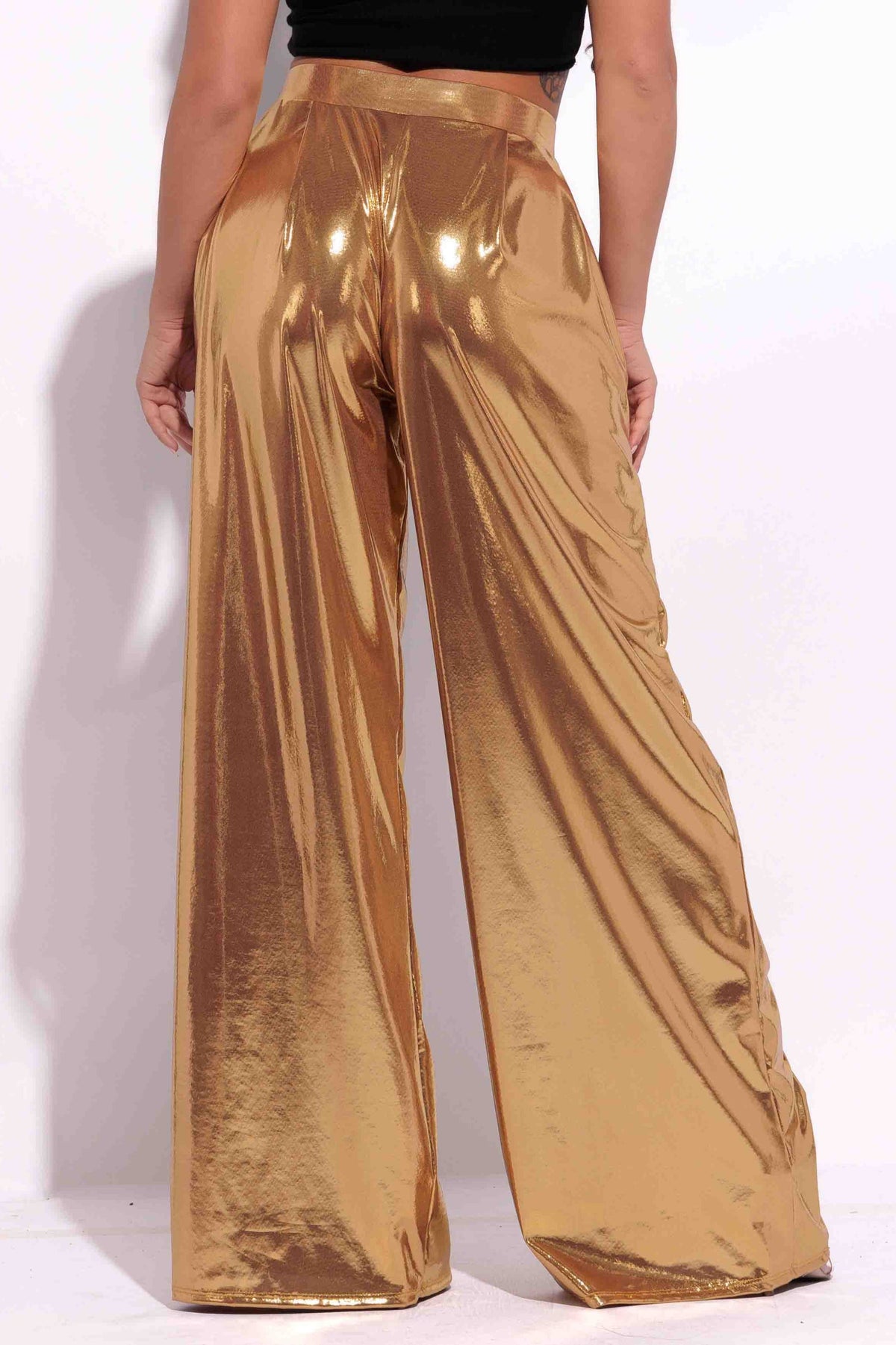 Gold metallic wide leg pants, close-up view on model