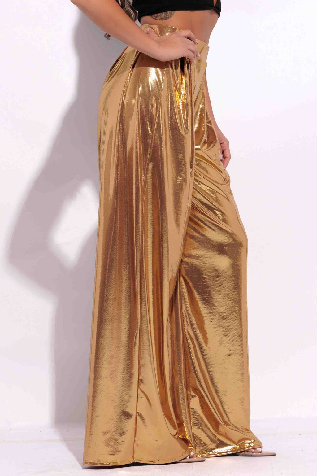 Gold metallic wide leg pants, full-length view on model