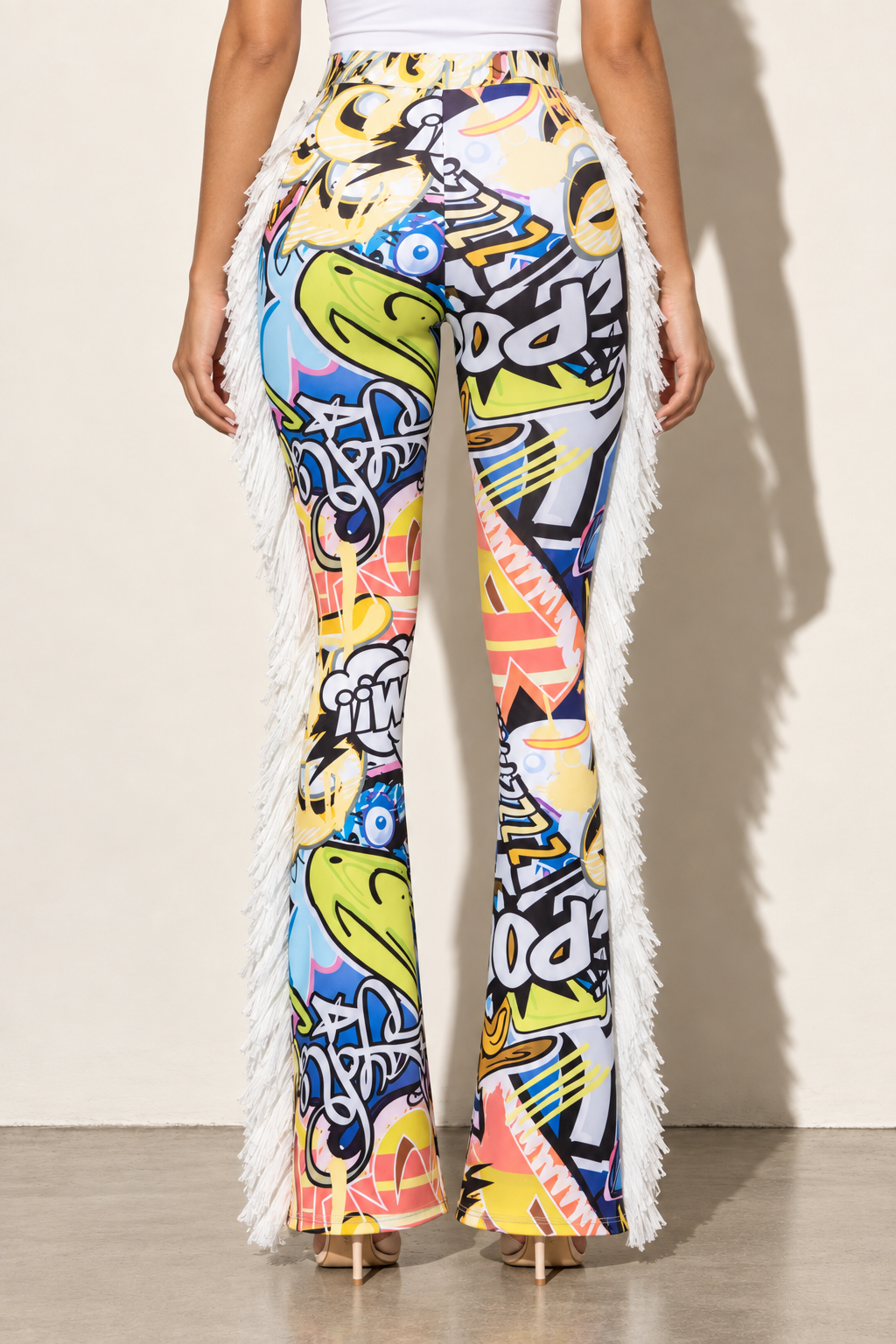 Multicolor graffiti print flared pants with white side fringe — back view