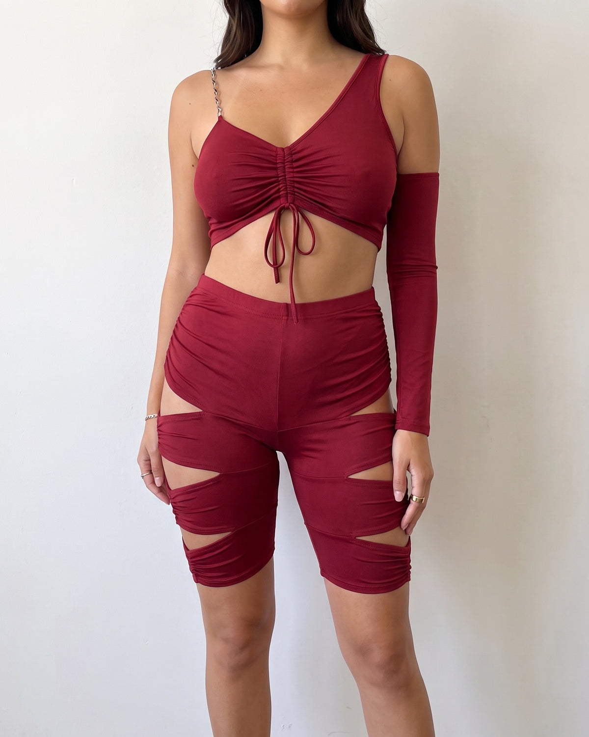Burgundy cutout detailed asymmetric top set, alternate front view on model