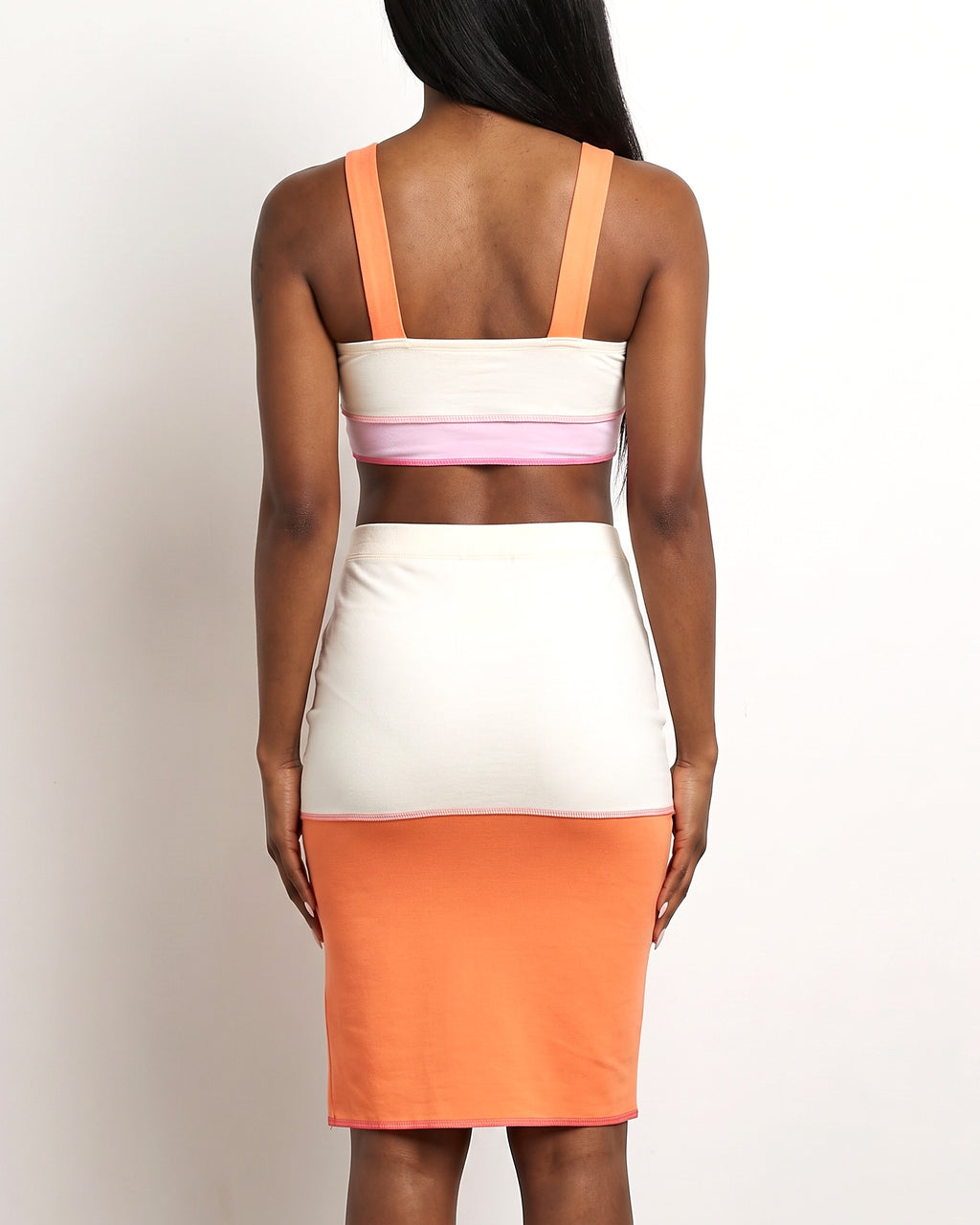 Orange multicolor binding detailed color block skirt set, back view on model