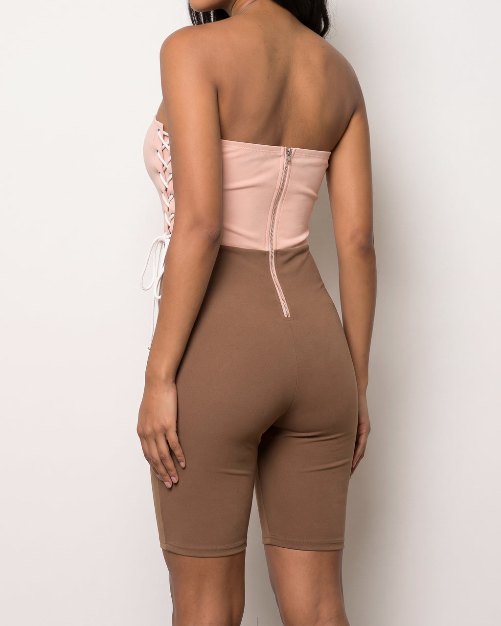 Brown and taupe strappy detailed tube romper, back view on model