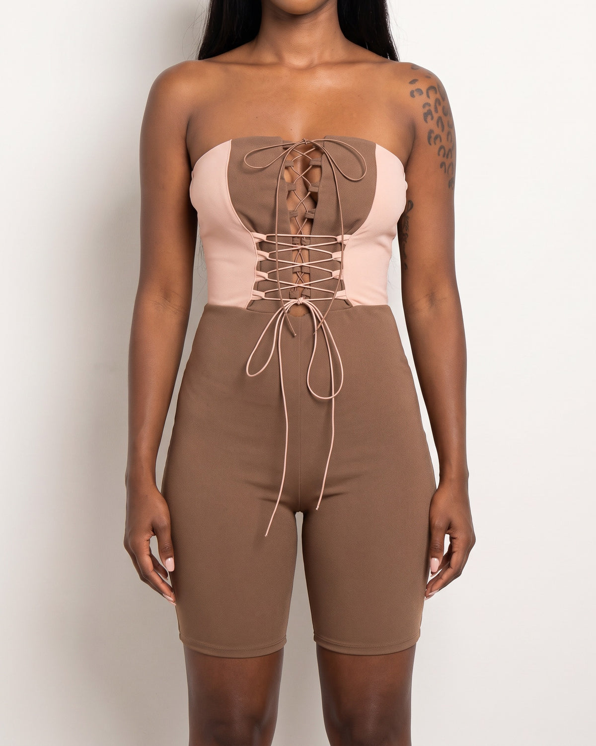 Brown and taupe strappy detailed tube romper, alternate front view on model
