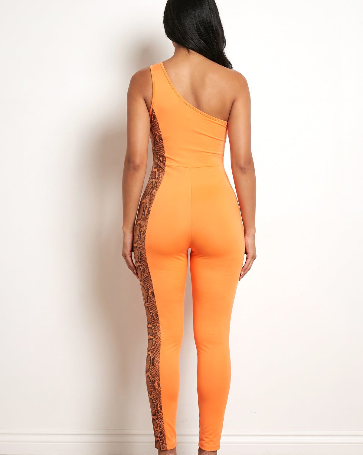 Orange asymmetric shoulder cut out jumpsuit, back view on model
