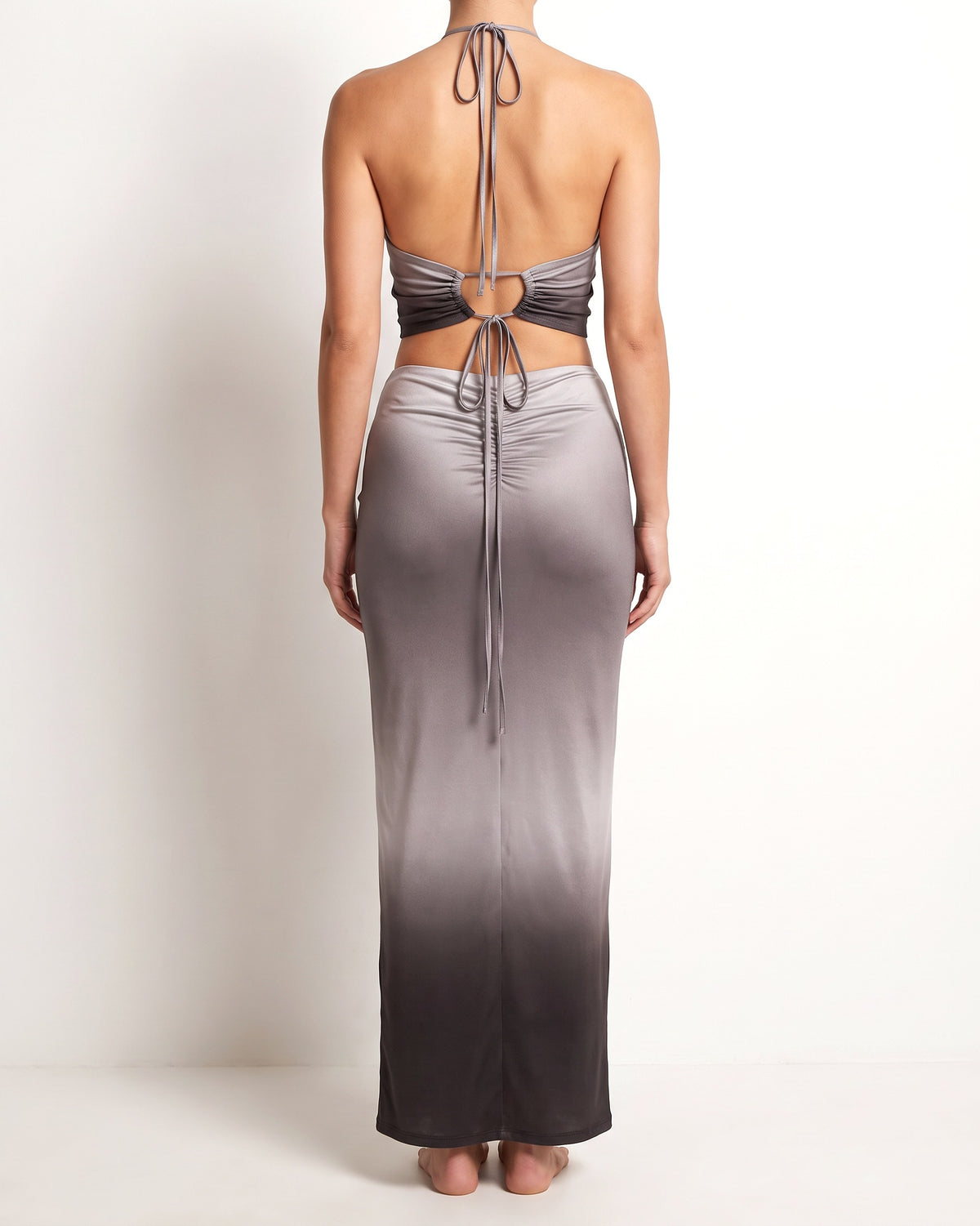 Black combo halter backless top and maxi skirt, back view on model