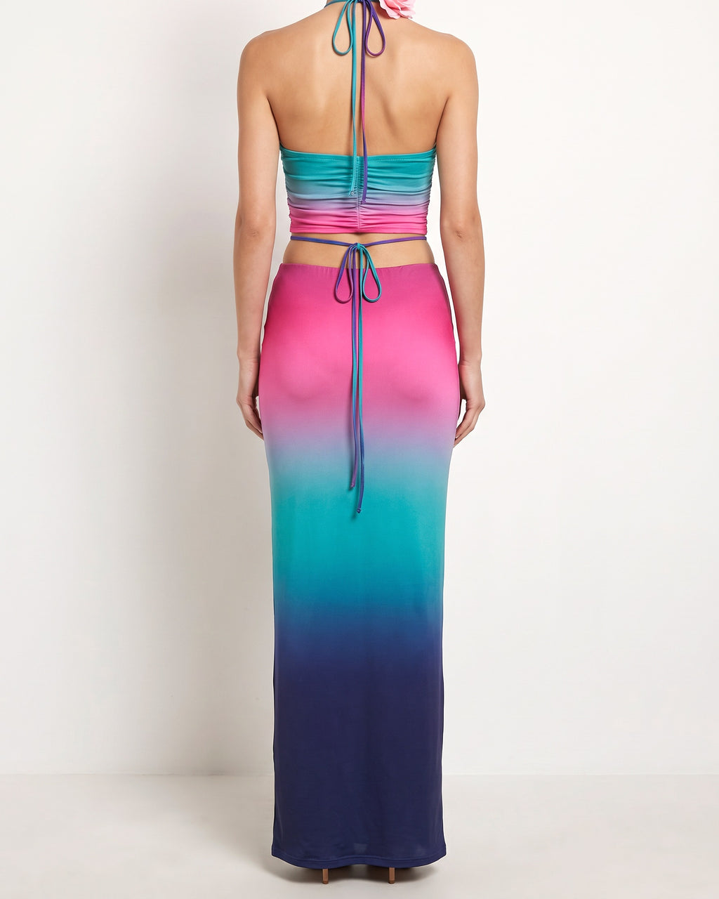 Multicolor combo halter backless top and maxi skirt, back view on model