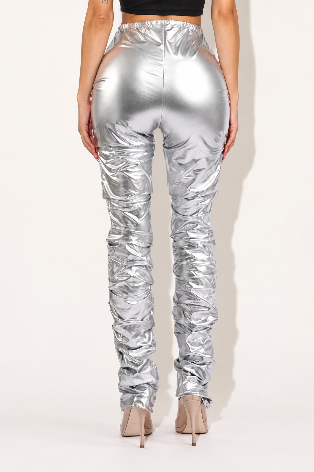 Silver metallic stacked pants, rear view showing plain back seam and gathered lower legs