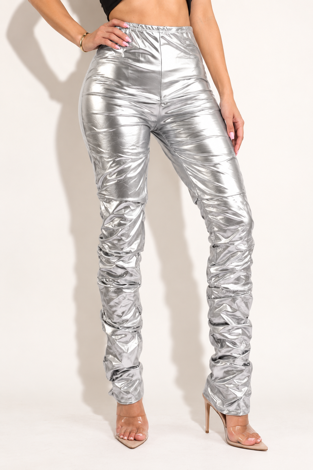 Silver metallic stacked pants, front angled view showing reflective silver finish and slim silhouette