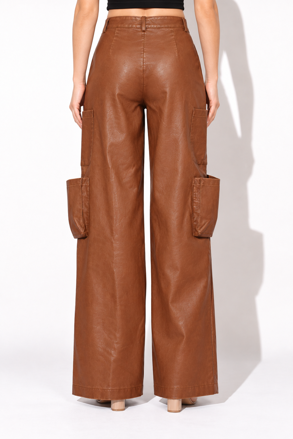 Brown faux leather wide leg utility pants, rear view showing belt loops and plain back with center seam