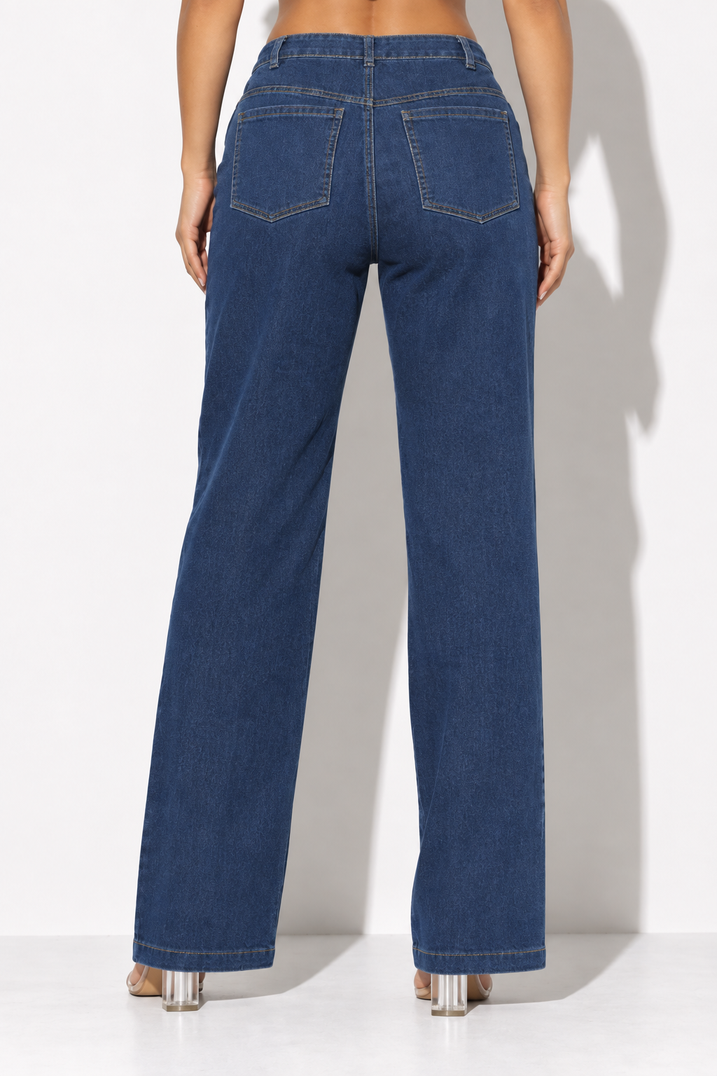 Distressed blue denim wide leg pants with pink and purple paint accents, rear view showing plain denim and two back pockets