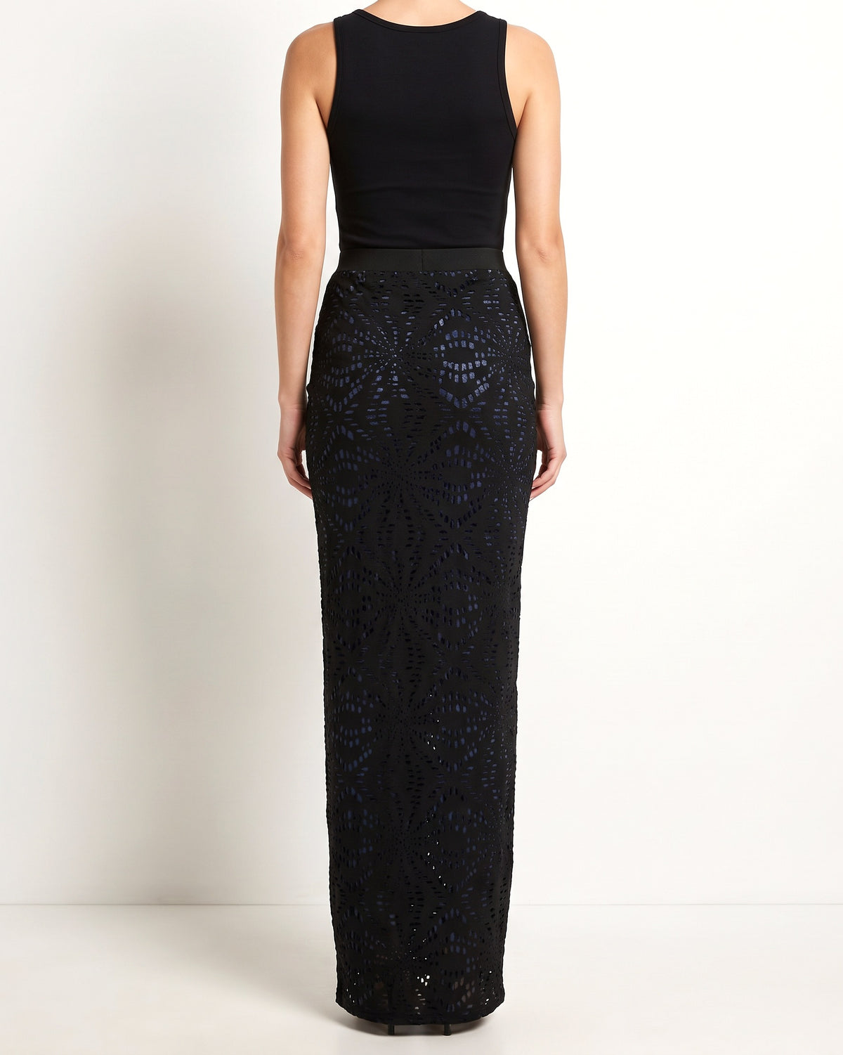 Black laser cut maxi skirt with tie dye print mesh lining, back view on model