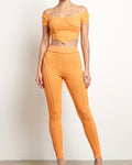 Muvin women's orange ribbed set with reverse overlock stitch detail, front view on model